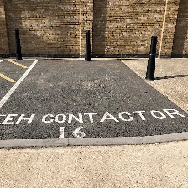 A photo of a misspelled road marking of Contractor with the middle R missing